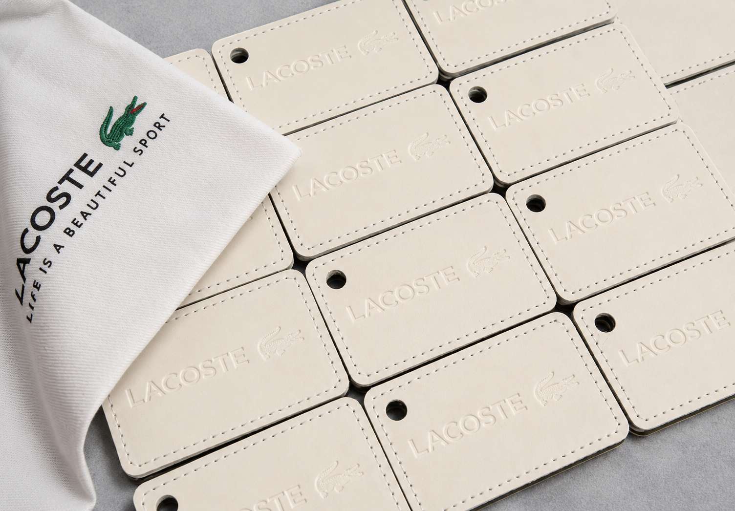 Lacoste Blind Debossed Cream Leather Luggage Tags