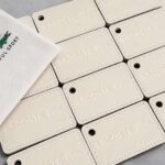 Lacoste Blind Debossed Cream Leather Luggage Tags